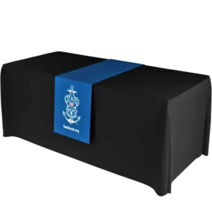 A black rectangular table with a blue runner featuring the Sea Scout logo—an anchor, eagle, and fleur-de-lis—and the text SeaScout.org.