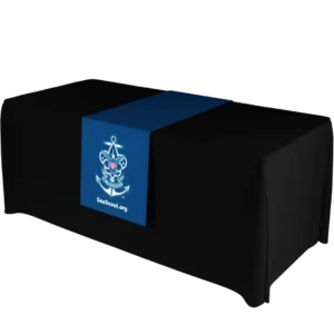 A black table with a navy blue runner featuring a white Sea Scouts emblem—an anchor, rope, and fleur-de-lis—above the text SeaScout.org.