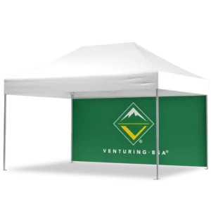 A white canopy tent with a green back panel featuring the Venturing BSA logo, which includes a mountain graphic inside a diamond shape and the text VENTURING, BSA below it.