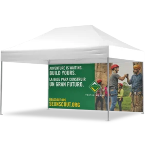 A white outdoor canopy tent with a banner showing Scouts in helmets and gear giving fist bumps. The text reads: ADVENTURE IS WAITING. BUILD YOURS. LA BASE PARA CONSTRUIR UN GRAN FUTURO. BEASCOUT.ORG SEUNSCOUT.ORG.