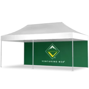 A white outdoor canopy tent with a green back wall featuring the Venturing BSA logo and the words Venturing BSA. The tent has four metal legs and provides shaded space underneath.