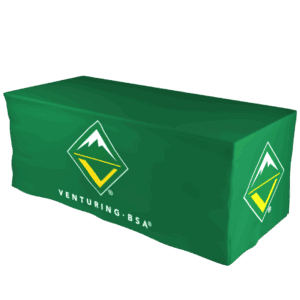 A green tablecloth with the Venturing BSA logo and text, covering a rectangular table. The logo features a stylized mountain and a yellow V inside a diamond shape.