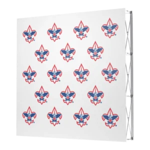 A white step-and-repeat backdrop featuring a repeating pattern of the Boy Scouts of America logo in red, white, and blue. The backdrop is supported by a metal frame on the right side.