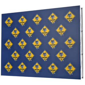 A blue backdrop featuring a repeated pattern of yellow diamond-shaped signs with a wolf head logo and text that reads The Wolf Den.