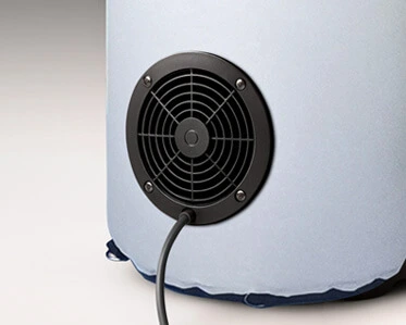A close-up of a black circular fan or air vent with a power cord attached, set in the side of a light blue inflatable object.