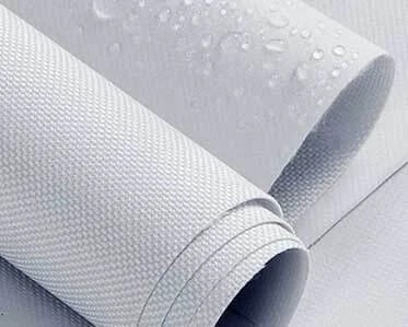 A close-up of two rolls of white textured waterproof fabric, with water droplets visible on the surface of the fabric, indicating its water-resistant properties.