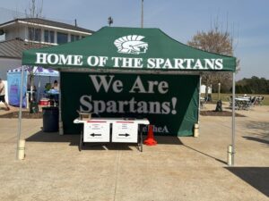 Green Spartans school pop-up tent with a "Home of the Spartans" canopy and a matching "We Are Spartans!" branded back wall.